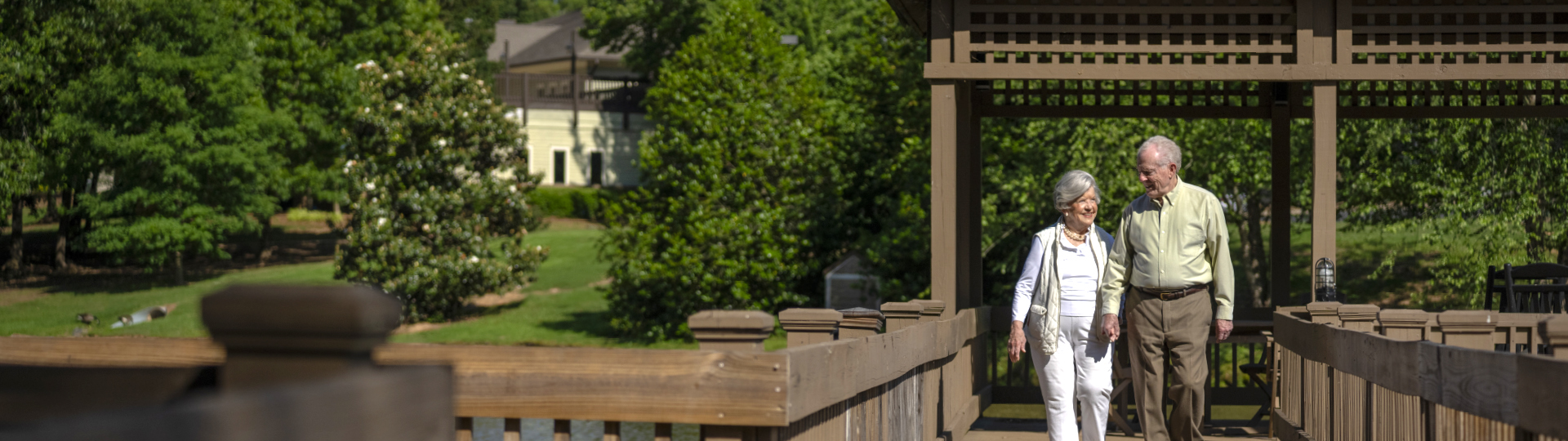Two seniors enjoy walking at a premier senior living community in cobb county, GA.