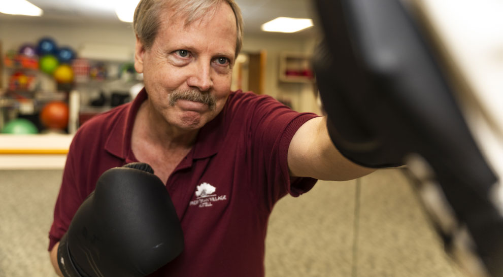 A senior man works out at a gym at Presbyterian Village Cobb.