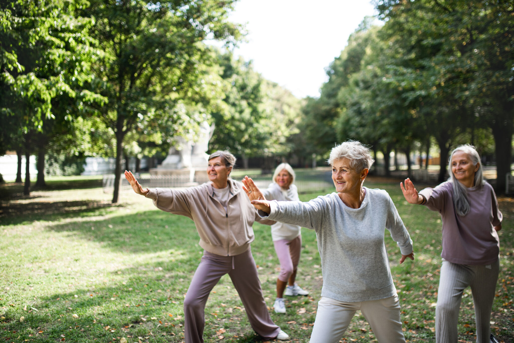 senior women exercising outdoors in a park